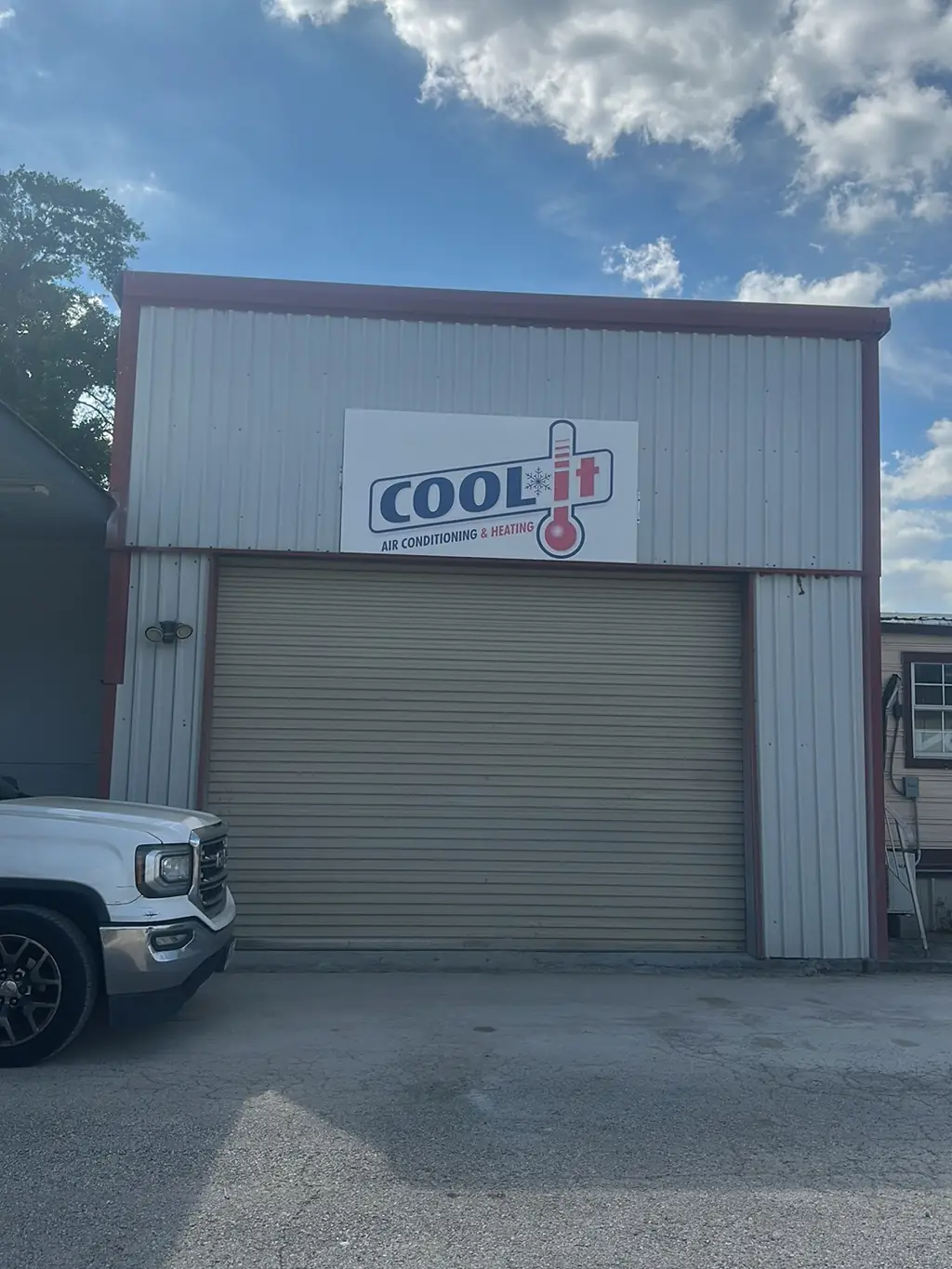 The Cool-It Air sign mounted on the front of the shop building
